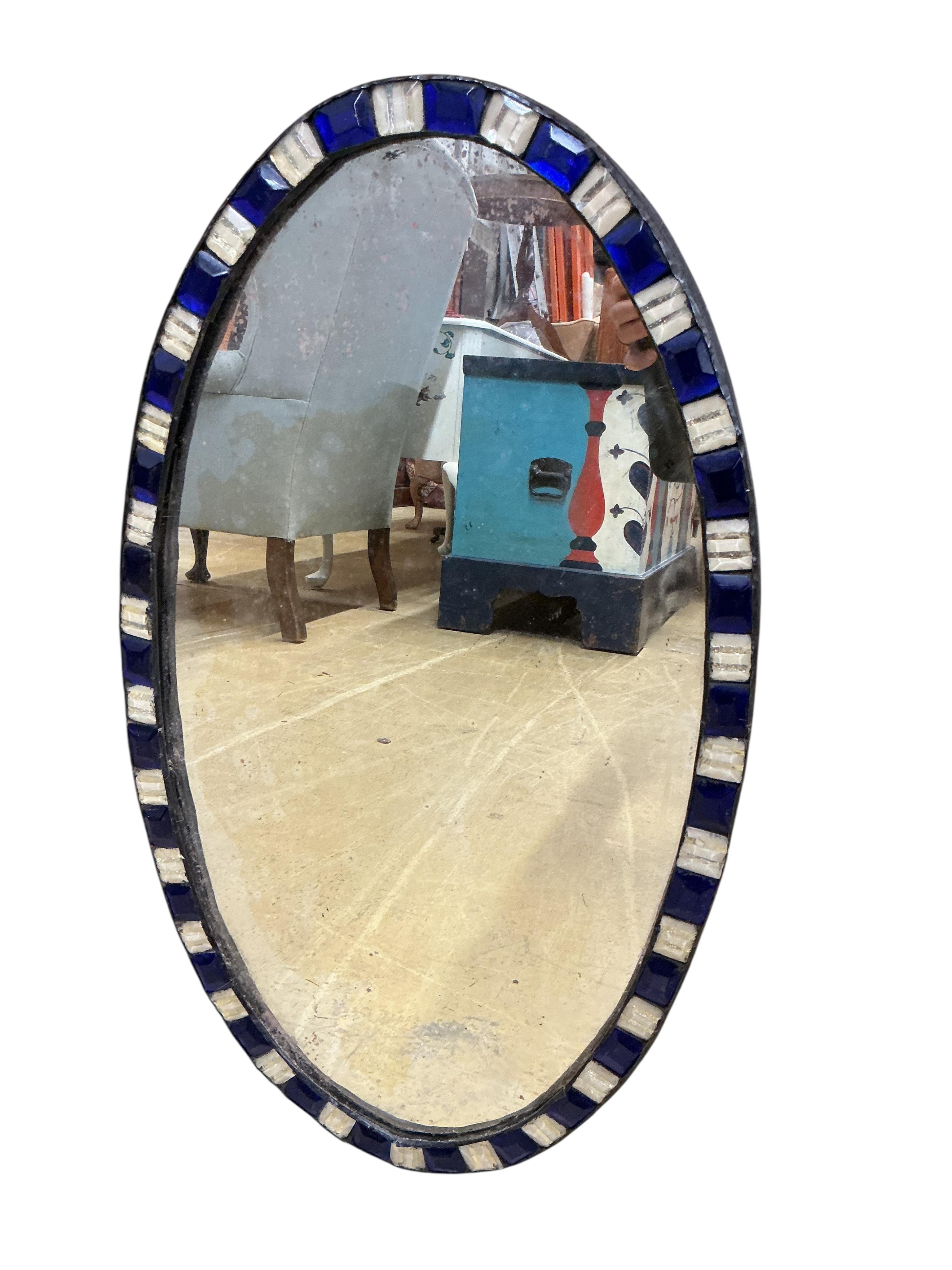An oval Irish style wall mirror, width 37cm, height 65cm